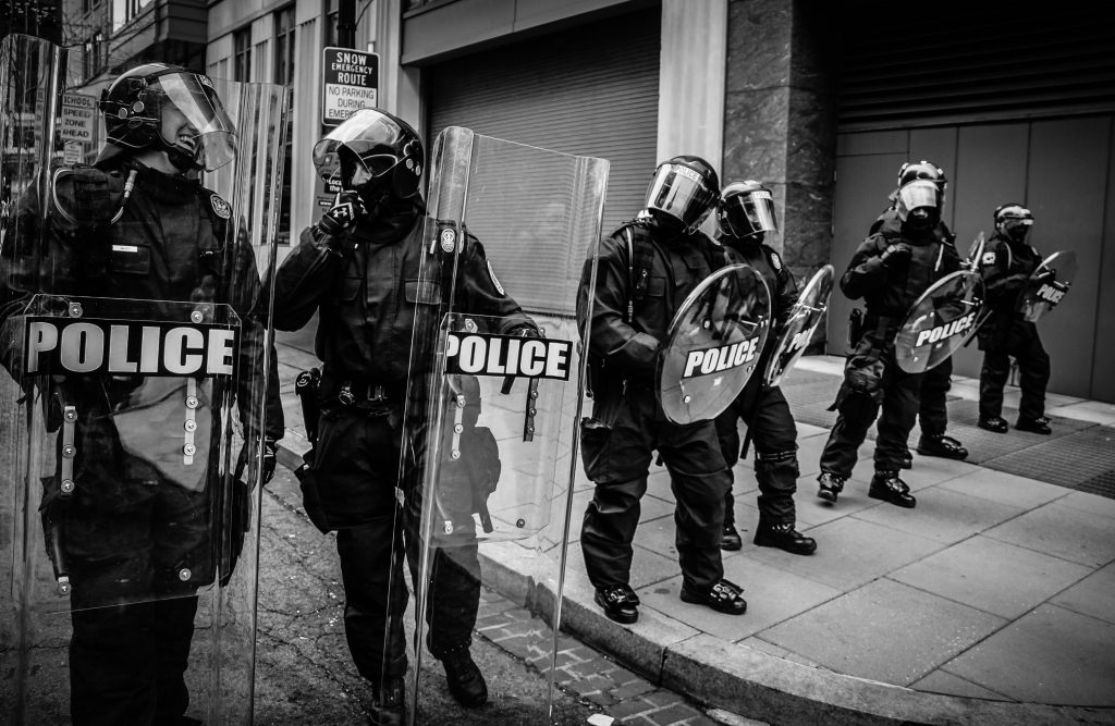 Police in riot gear walking in the streets