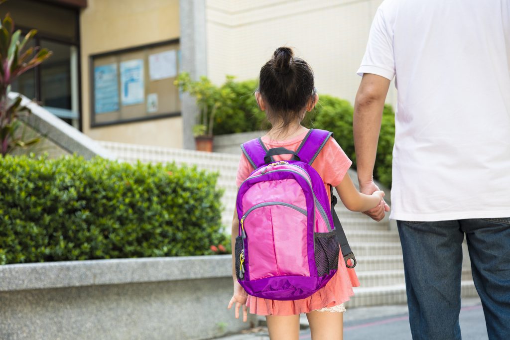 Father Walking To School With Children together